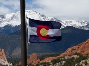 colorado flag with mountains in background RDS Environmental Colorado